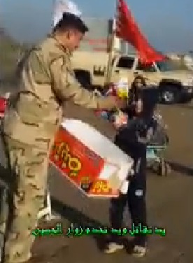 بالفيديو :يد تقاتل ويد تخدم زوار ابي عبد الله الحسين عليه السلام