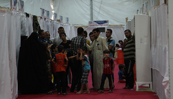 بالصور:كربلاء تودّع (1411) نازحاً  رجعوا الى مناطقهم بعد تحريرها من دنس داعش