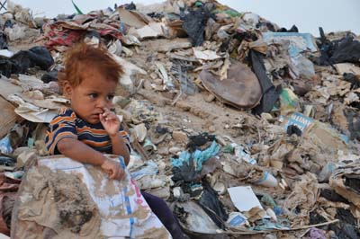 طفل عراقي يلعب وسط  الطمر الصحي بكربلاء