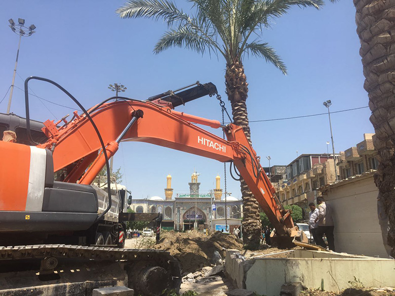 بالصور.. لهذا السبب تم تجريف النخيل من باب قبلة مرقد الإمام الحسين بعد عقدين من غرسها