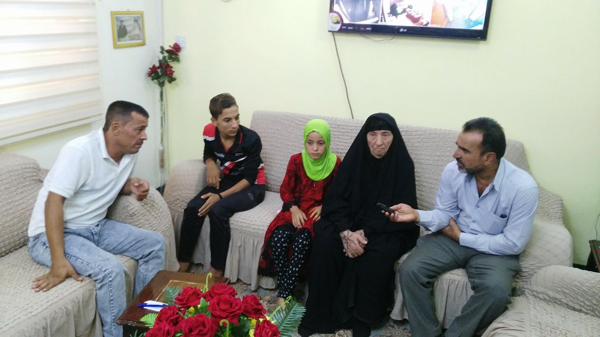 بالصور: نازحة موصلية مسنة في كربلاء تعيل أيتام لأسر (10) شهداء