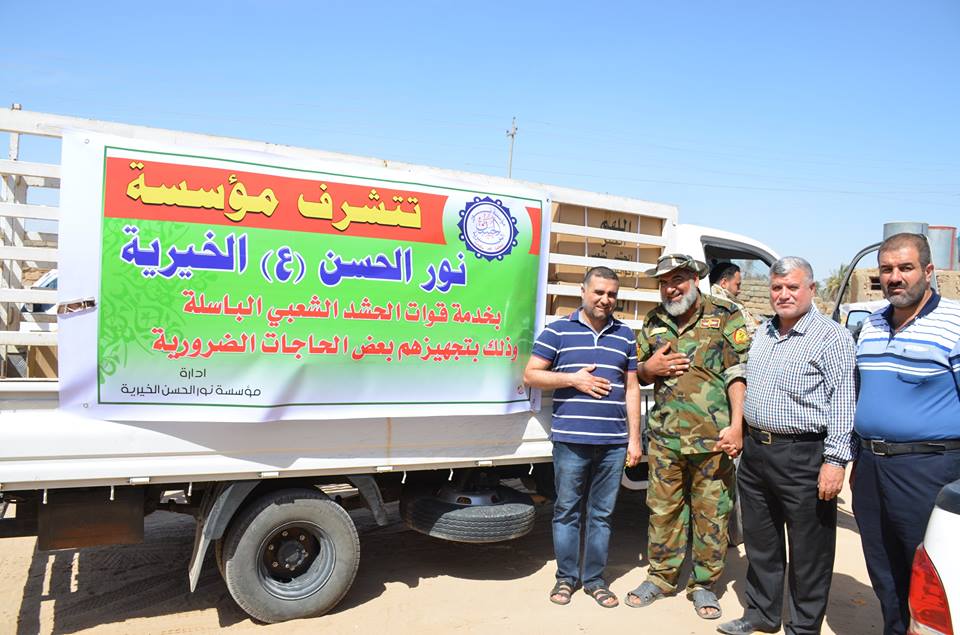 بالصور:مؤسسة نور الحسن الخيرية تتجول بين قطعات الحشد الشعبي في بيجي